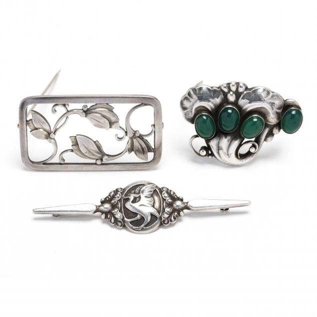 three-sterling-silver-brooches-and-a-sterling-silver-and-gem-set-brooch-georg-jensen