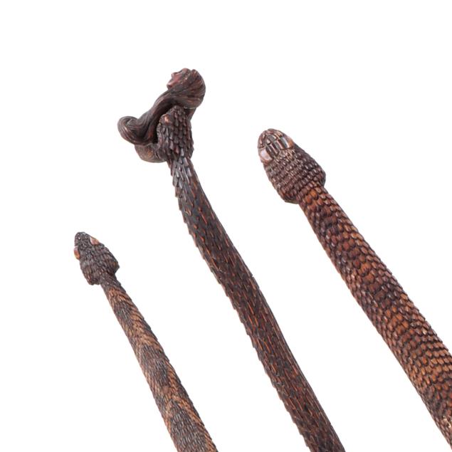 three-folk-carved-wood-walking-sticks-fashioned-as-poisonous-snakes