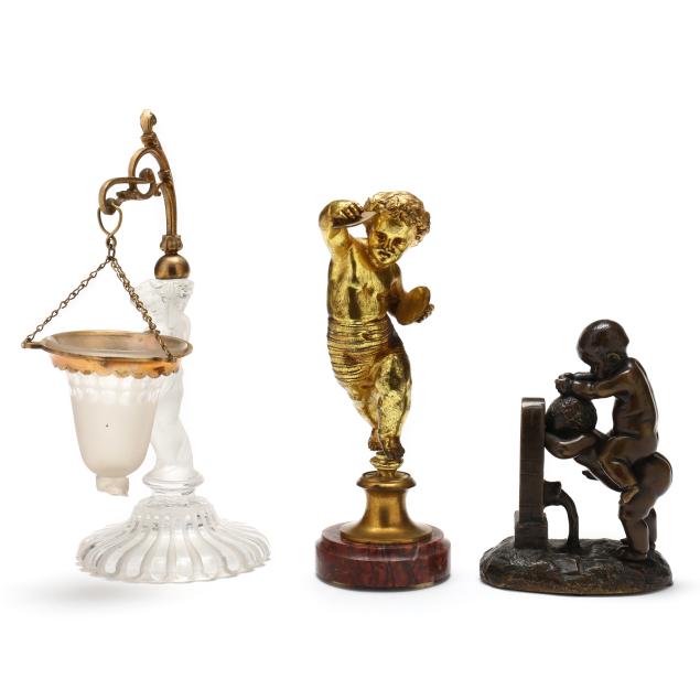 three-sculptural-objets-d-art-featuring-putti-including-baccarat