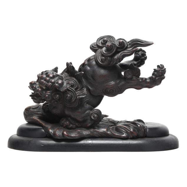 an-asian-carved-wood-foo-lion-in-base