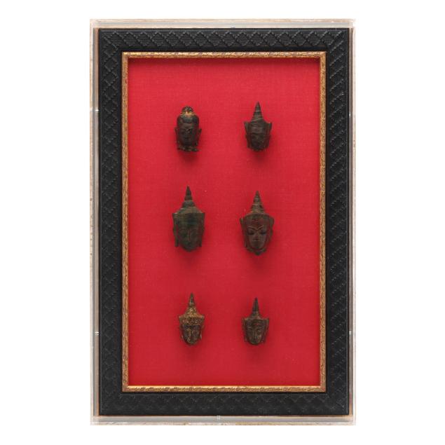 a-group-of-six-southeast-asian-bronze-buddha-heads-framed