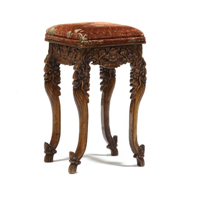 an-asian-carved-wood-stool-with-plush-seat