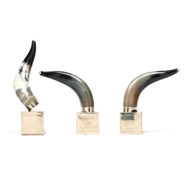 three-polished-horns-on-pedestals