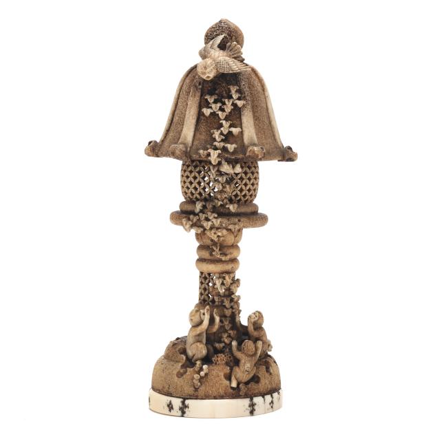 a-japanese-staghorn-carving-of-a-lantern-with-eagle-and-monkeys