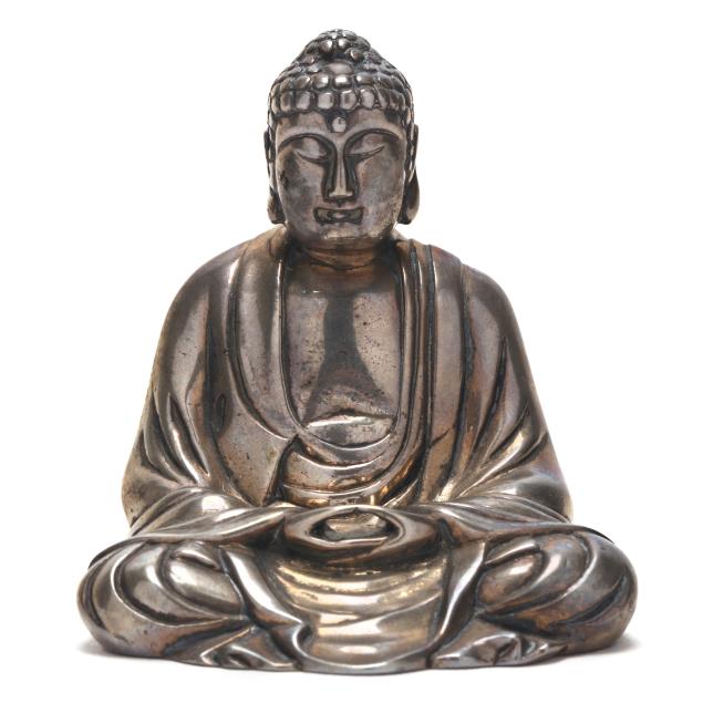 a-small-silver-buddha-with-inscription