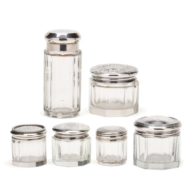 a-collection-of-six-silver-lidded-cut-glass-vanity-jars