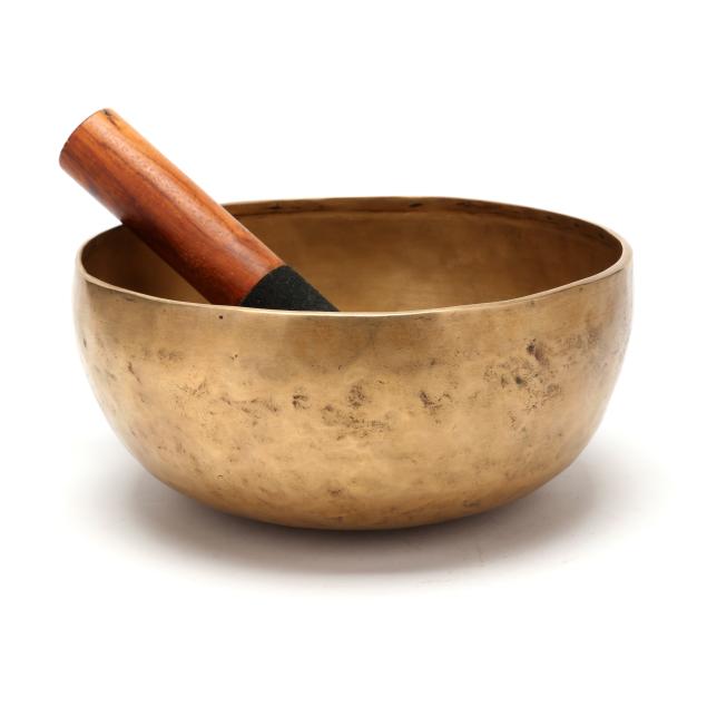 a-southeast-asian-hammered-brass-singing-bowl