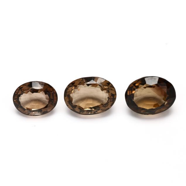 a-group-of-three-oval-cut-loose-smoky-quartz