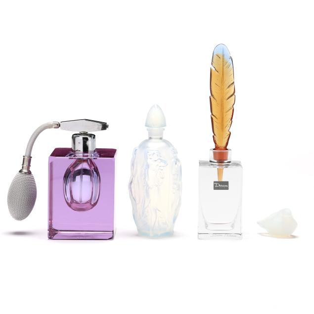three-glass-perfume-bottles-and-a-bird