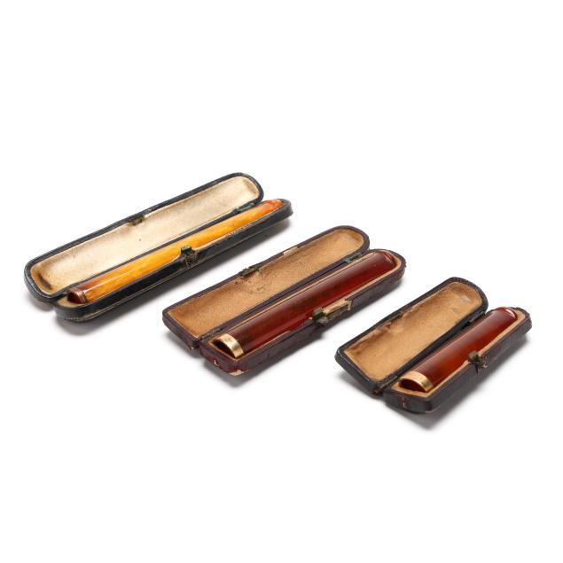 three-cased-art-deco-amber-and-14k-gold-cigarette-holders-including-tiffany-co