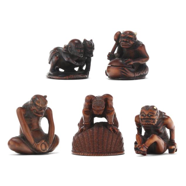 a-group-of-five-japanese-carved-boxwood-netsuke-of-oni