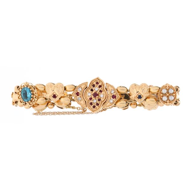 gold-and-gem-set-slide-charm-bracelet-with-richard-glatter-charms