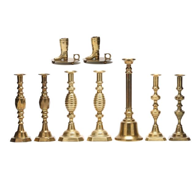 a-collection-of-nine-assorted-brass-candlesticks
