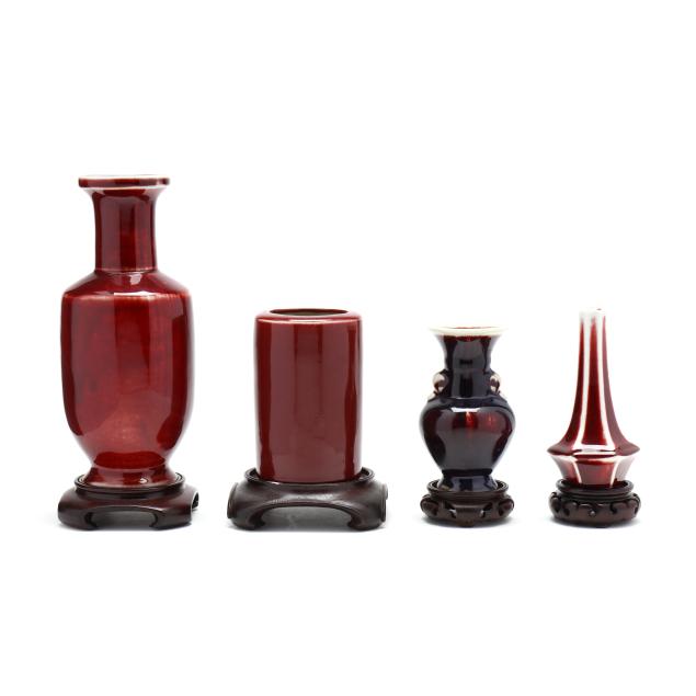 a-collection-of-sang-de-boeuf-vases-with-stands
