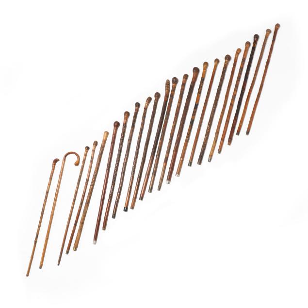 a-collection-of-22-hand-carved-japanese-walking-canes-with-landscapes