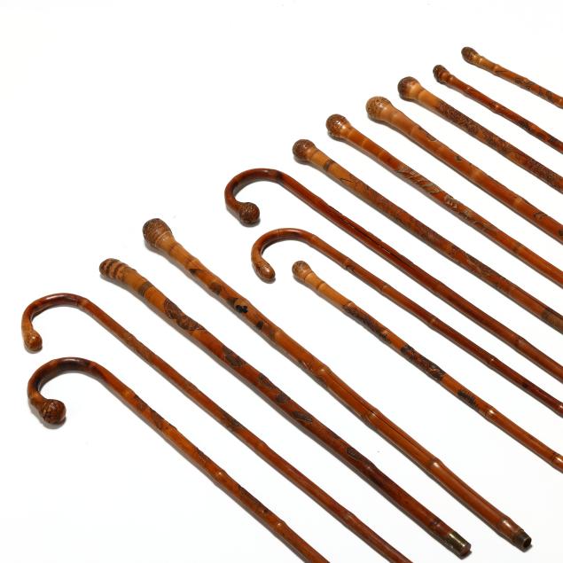 a-collection-of-13-hand-carved-japanese-walking-canes-with-inscriptions