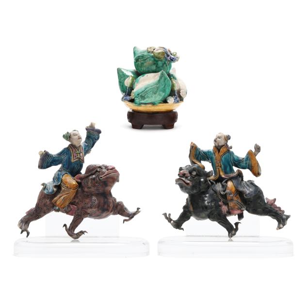 a-pair-of-chinese-ceramic-warrior-roof-tiles-and-a-bowl-of-peaches