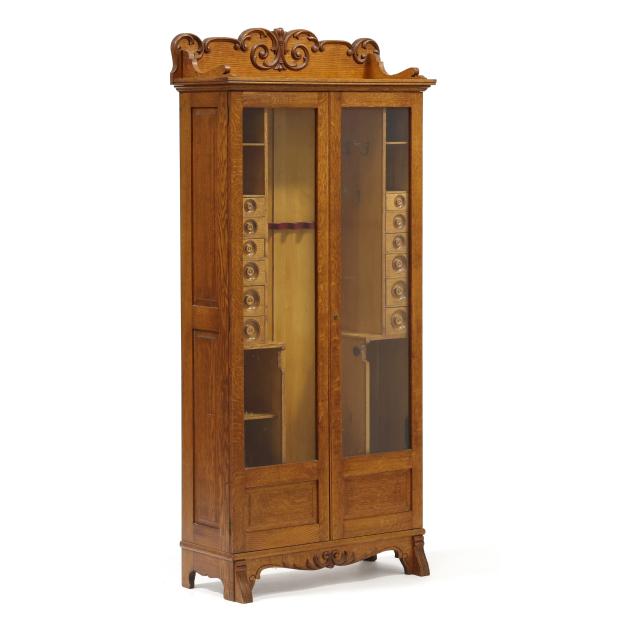 henry-c-squires-metamorphic-oak-gun-cabinet