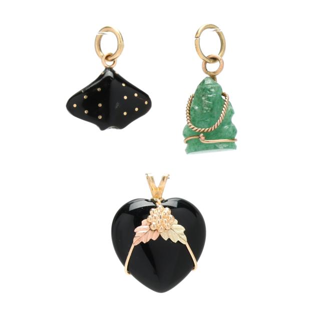 three-gold-and-carved-gemstone-pendants