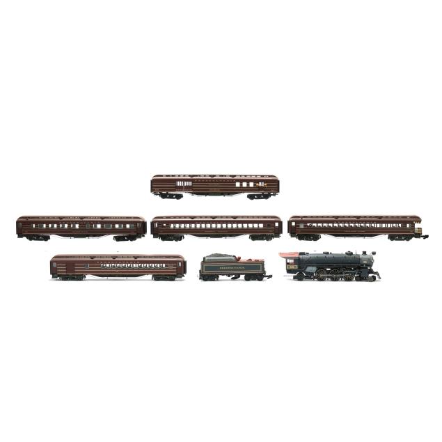a-large-group-of-model-train-cars-tracks-and-accessories