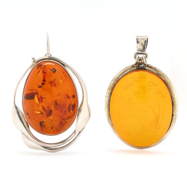 two-silver-and-amber-pendants