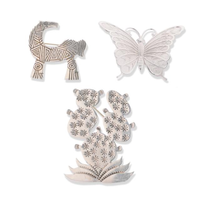 three-silver-brooches