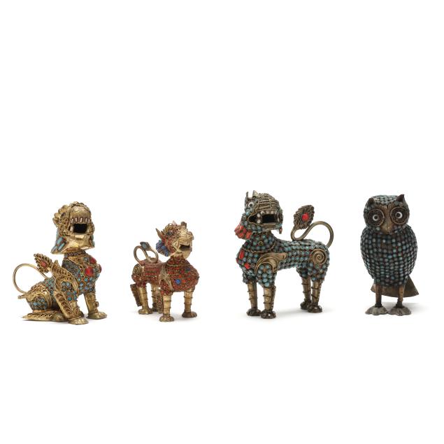 a-collection-of-four-tibetan-metal-figurines-with-turquoise-and-coral-inlay