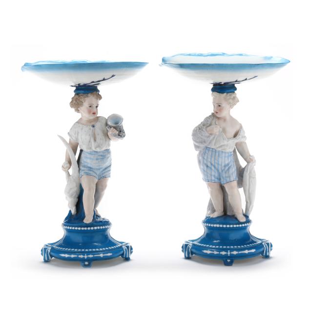vion-baury-pair-of-porcelain-tazzas-modeled-as-youth-holding-game