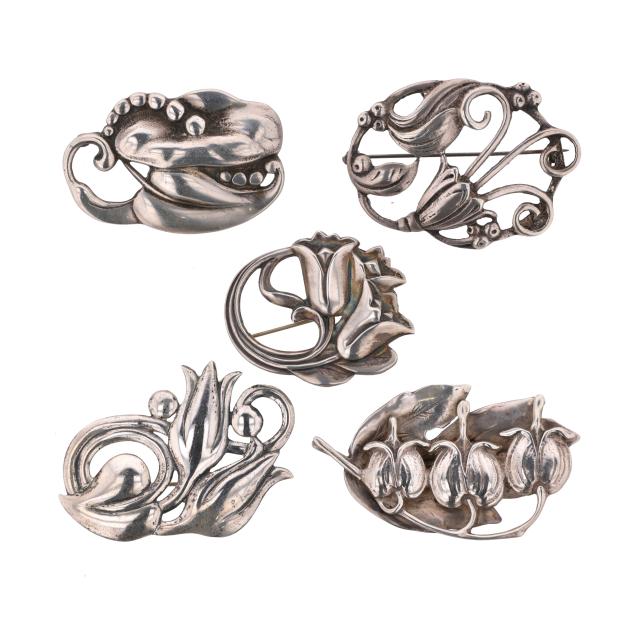 group-of-five-silver-floral-and-foliate-motif-brooches