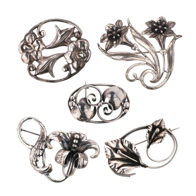 group-of-five-silver-floral-and-foliate-motif-brooches