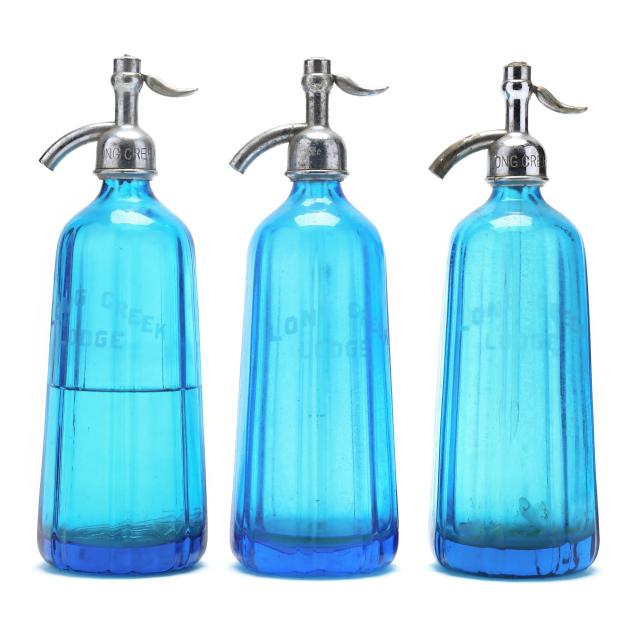 three-vintage-selzer-bottles-advertising-long-creek-lodge